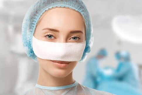 A bandage is attached to the nose during recovery after rhinoplasty